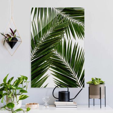Glasbild - Blick durch grüne Palmenblätter - Hochformat