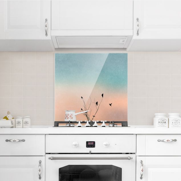 Küchenrückwand Glas Motiv Wald Vögel vor rosa Sonne II