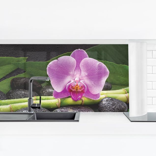 Küchenrückwand Glas Blumen Grüner Bambus mit Orchideenblüte