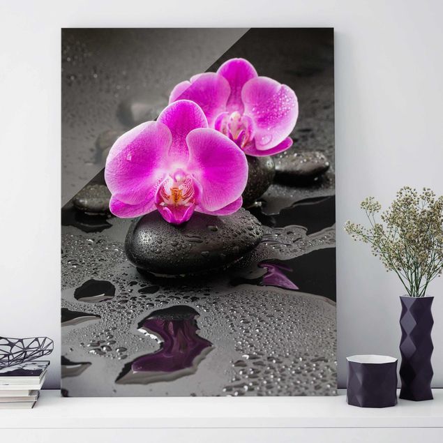 Glasbild Orchidee Pinke Orchideenblüten auf Steinen mit Tropfen