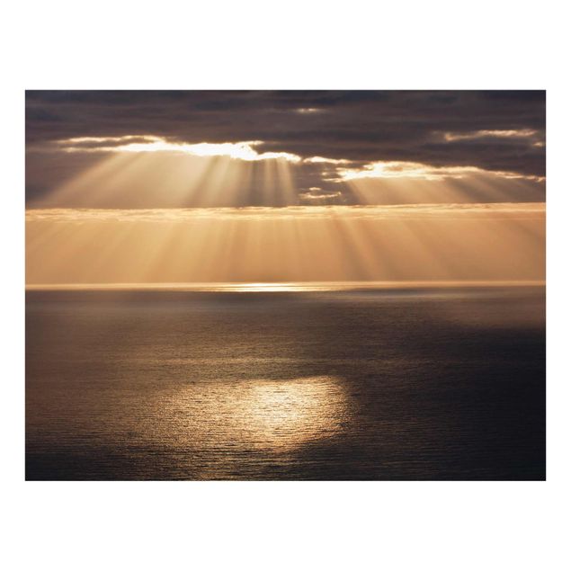 Bilder auf Glas Sonnenstrahlen über dem Meer
