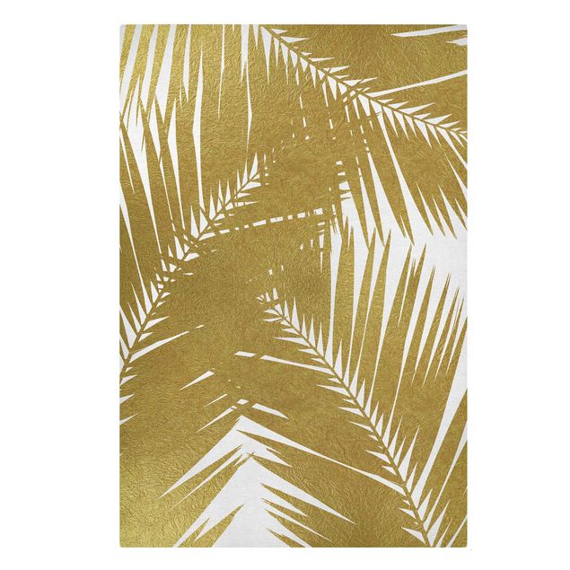 Wandbilder Wohnzimmer modern Blick durch goldene Palmenblätter