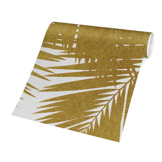 Schöne Fototapete Blick durch goldene Palmenblätter