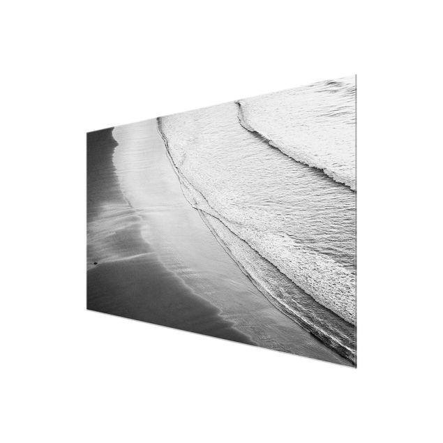 Glasbild - Leichter Wellengang am Strand Schwarz Weiß - Querformat