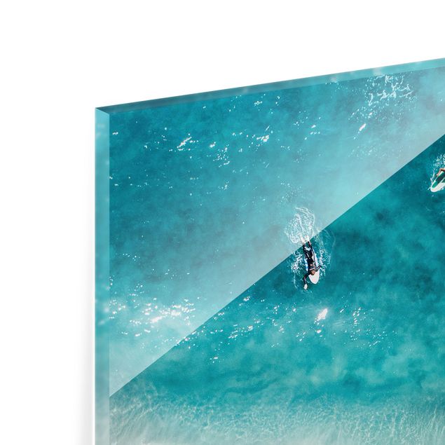 Glasbild - Drei Surfer paddeln zum Ufer - Hochformat