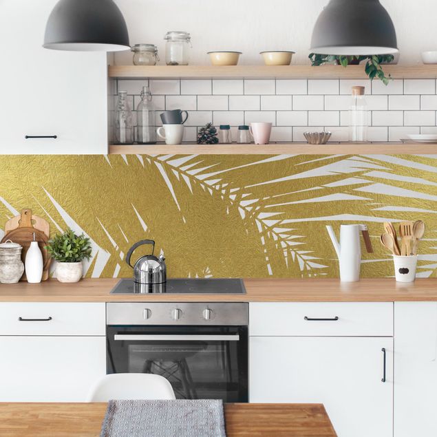 Küchenrückwand Glas Landschaft Blick durch goldene Palmenblätter